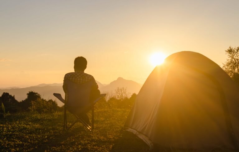 man in sunset exploring benefits of solo camping